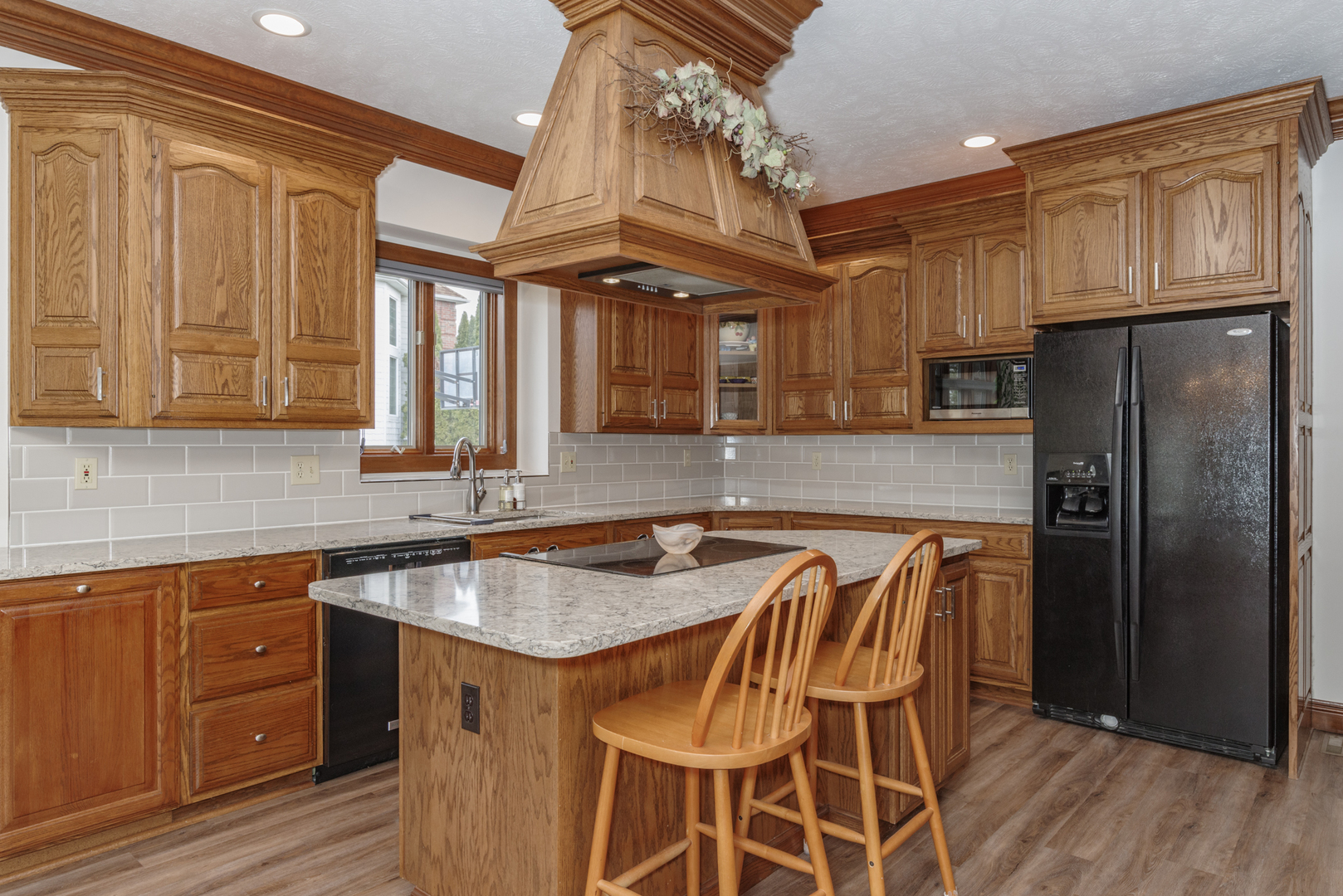 1908 Hackberry Road Bloomington, IL 61704 - Photo 15 of 50 a kitchen with granite countertop a table chairs stove refrigerator and cabinets