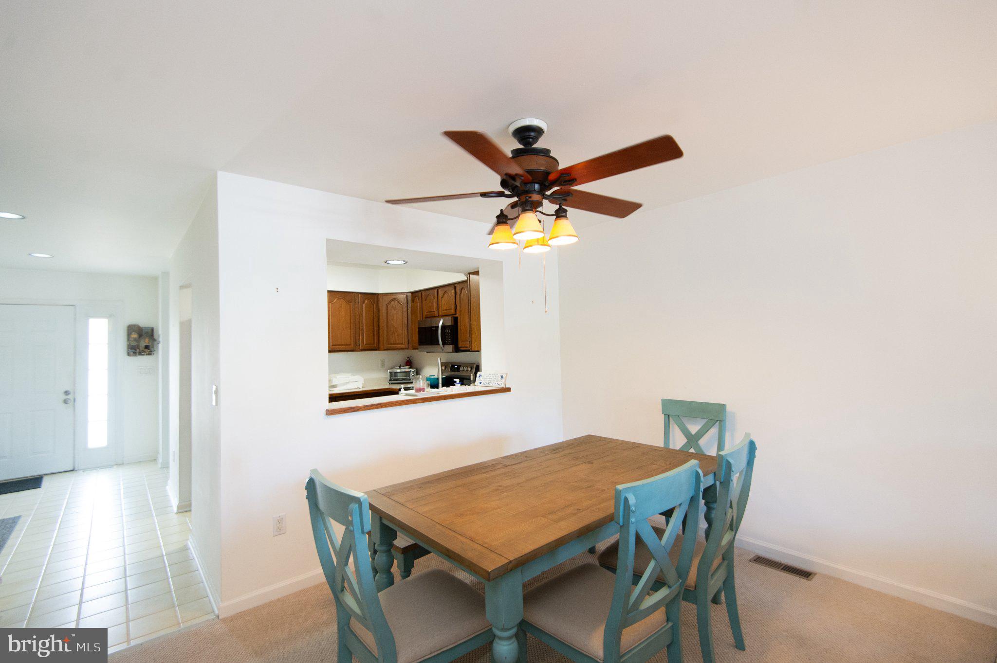 101 Main Street, Unit 119 Secretary, MD 21664 - Photo 14 of 58 Bright dining space with charming accents.