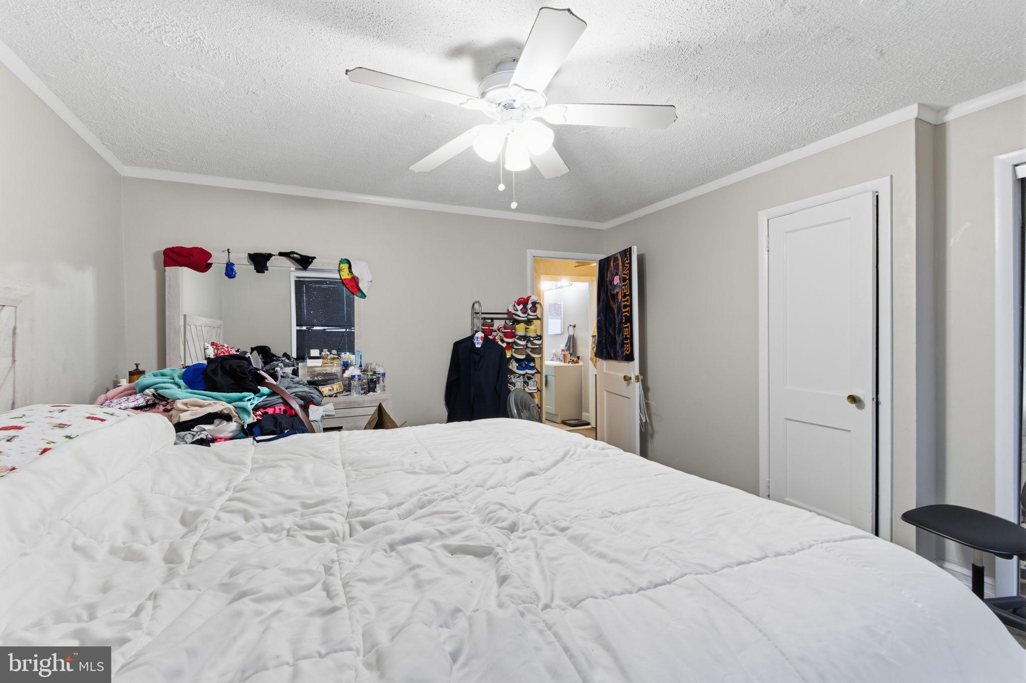 4524 Robbins Street Philadelphia, PA 19135 - Photo 14 of 26 a bedroom with a bed and a chandelier