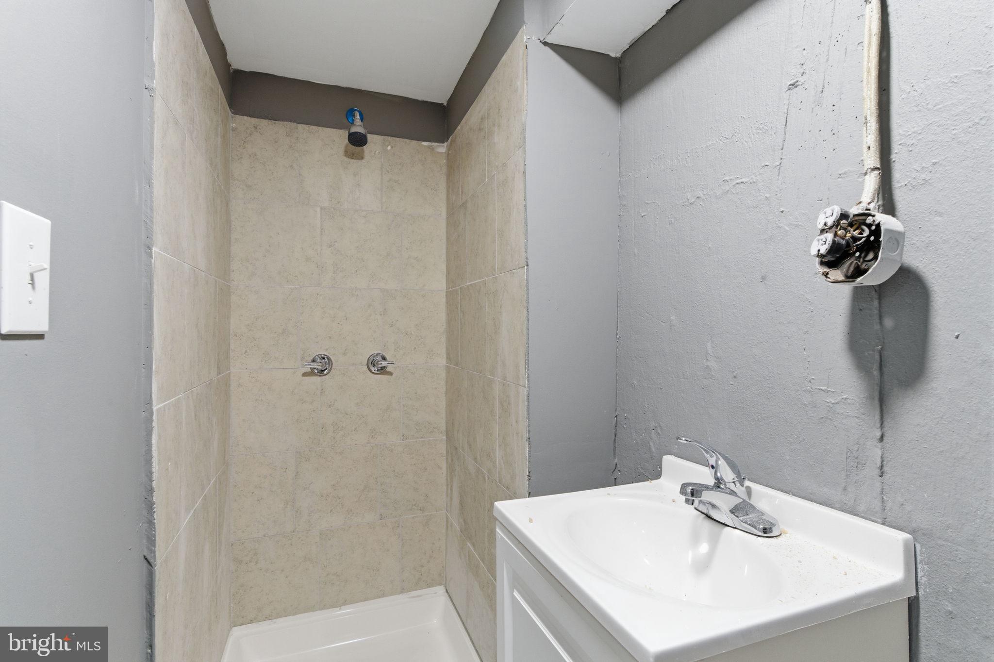 4524 Robbins Street Philadelphia, PA 19135 - Photo 18 of 26 a bathroom with a sink a shower and a vanity