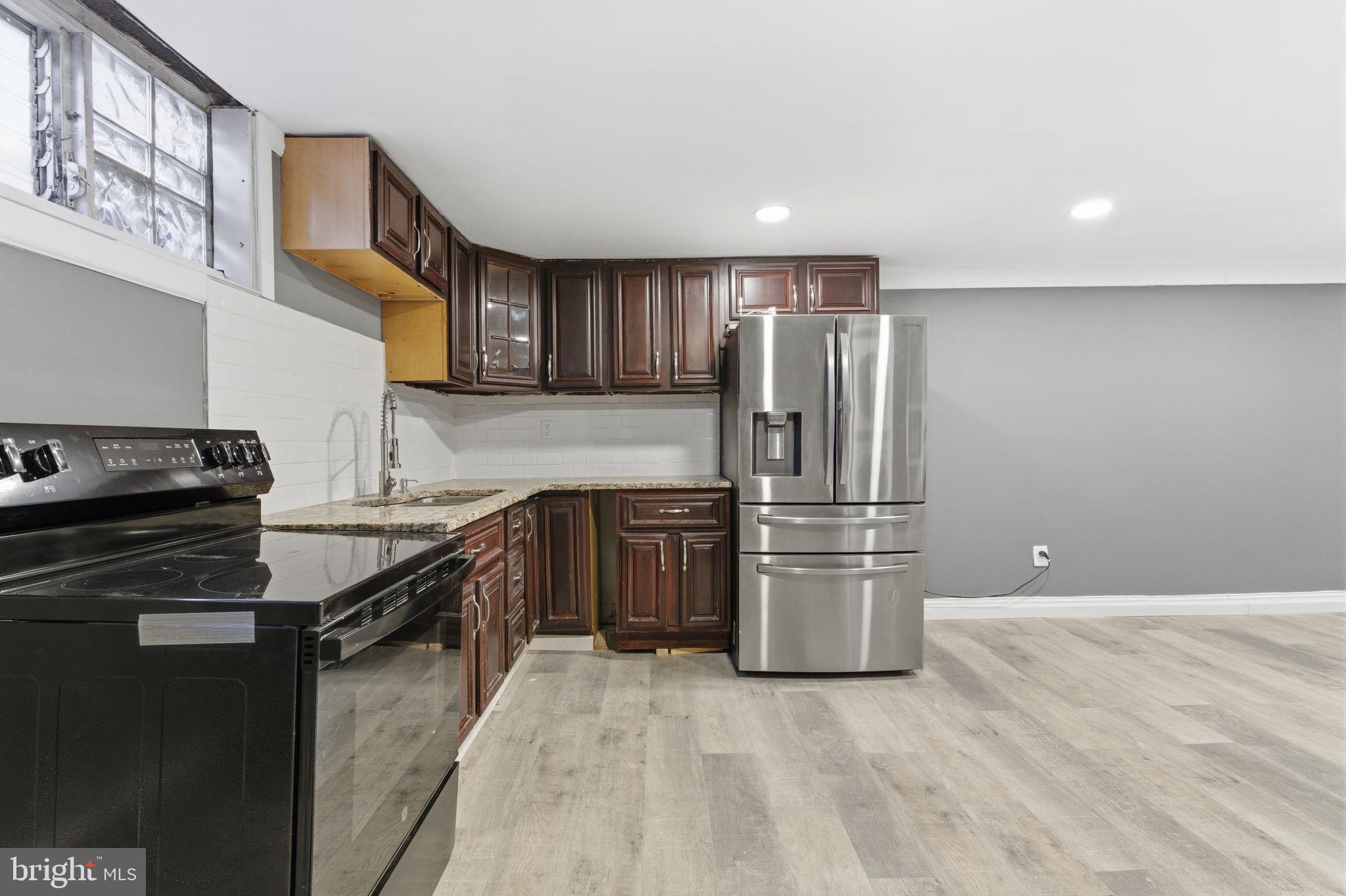 4524 Robbins Street Philadelphia, PA 19135 - Photo 20 of 26 a kitchen with a refrigerator stove and sink