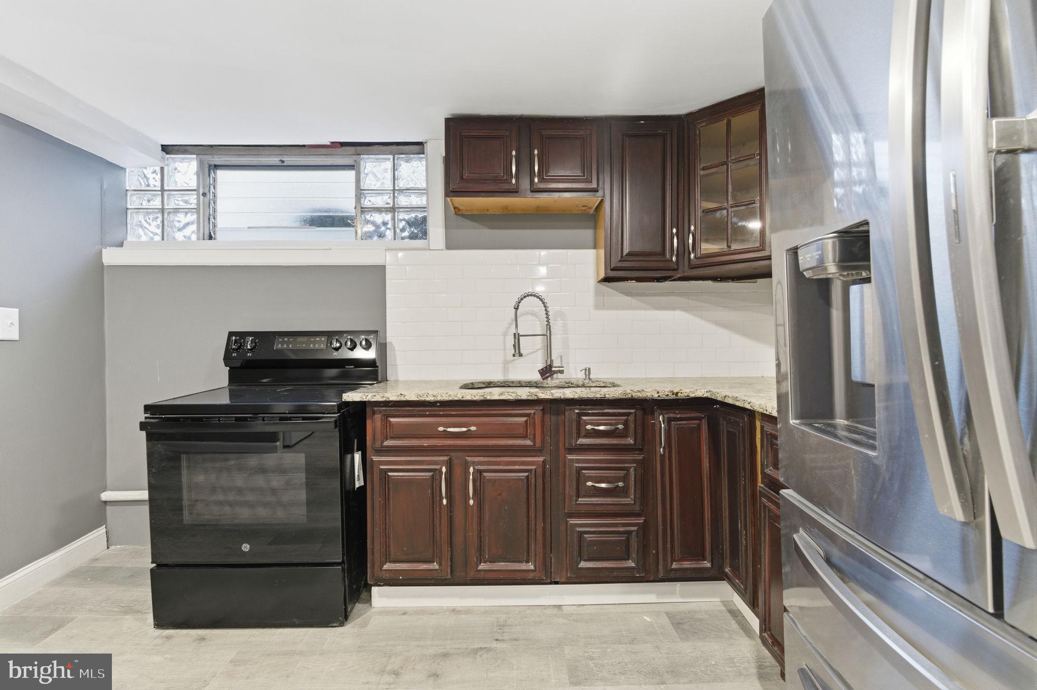 4524 Robbins Street Philadelphia, PA 19135 - Photo 21 of 26 a kitchen with a sink and cabinets