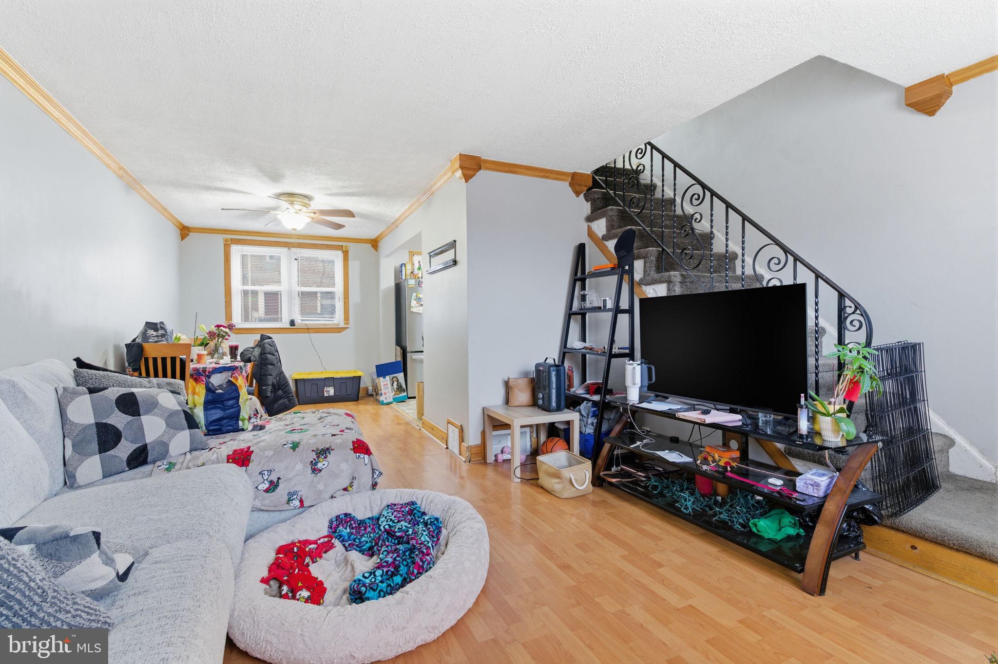 4524 Robbins Street Philadelphia, PA 19135 - Photo 4 of 26 a living room with furniture and a flat screen tv