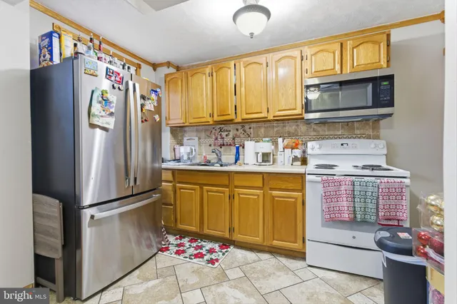 a kitchen with stainless steel appliances a refrigerator and cabinets