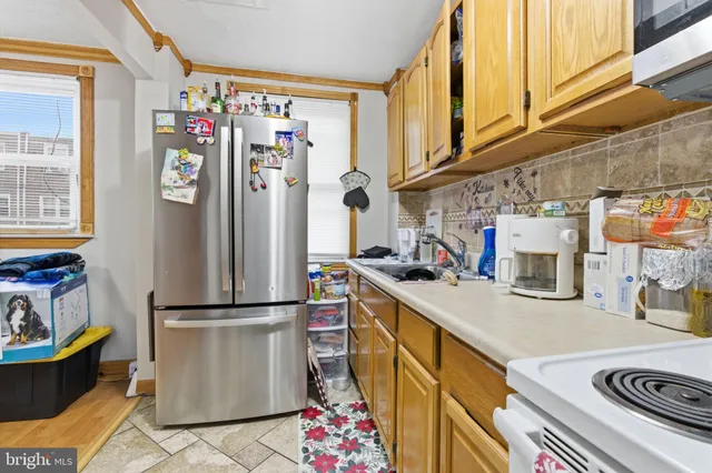 a kitchen with refrigerator and stove