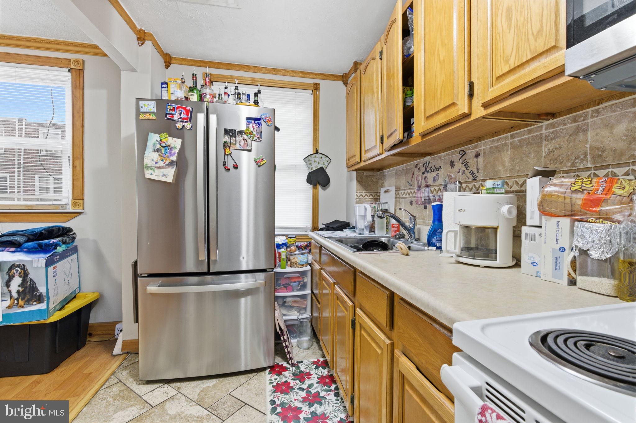 4524 Robbins Street Philadelphia, PA 19135 - Photo 8 of 26 a kitchen with refrigerator and stove