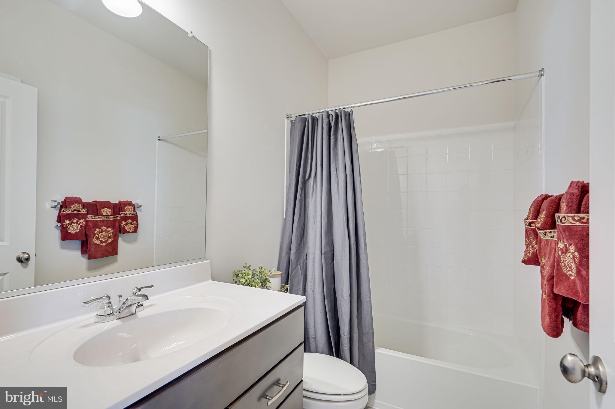 9536 Barnes Loop Manassas, VA 20110 - Photo 19 of 24 a bathroom with a sink vanity and toilet