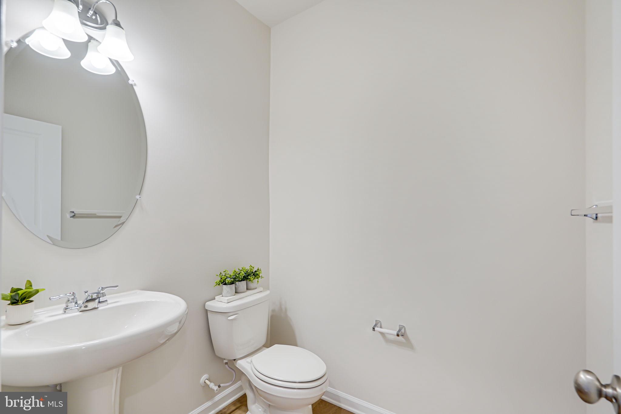9536 Barnes Loop Manassas, VA 20110 - Photo 5 of 24 a bathroom with a toilet a sink and mirror