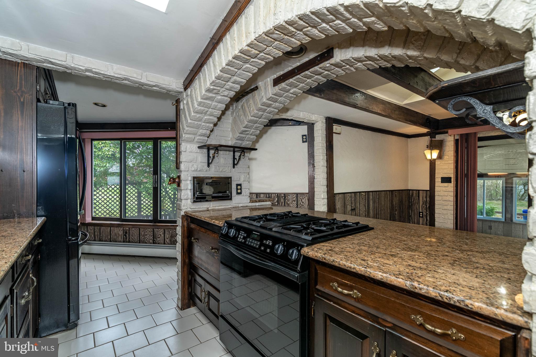 520 Powell Road Mount Holly, NJ 08060 - Photo 15 of 65 a kitchen with granite countertop a stove and a wooden cabinets