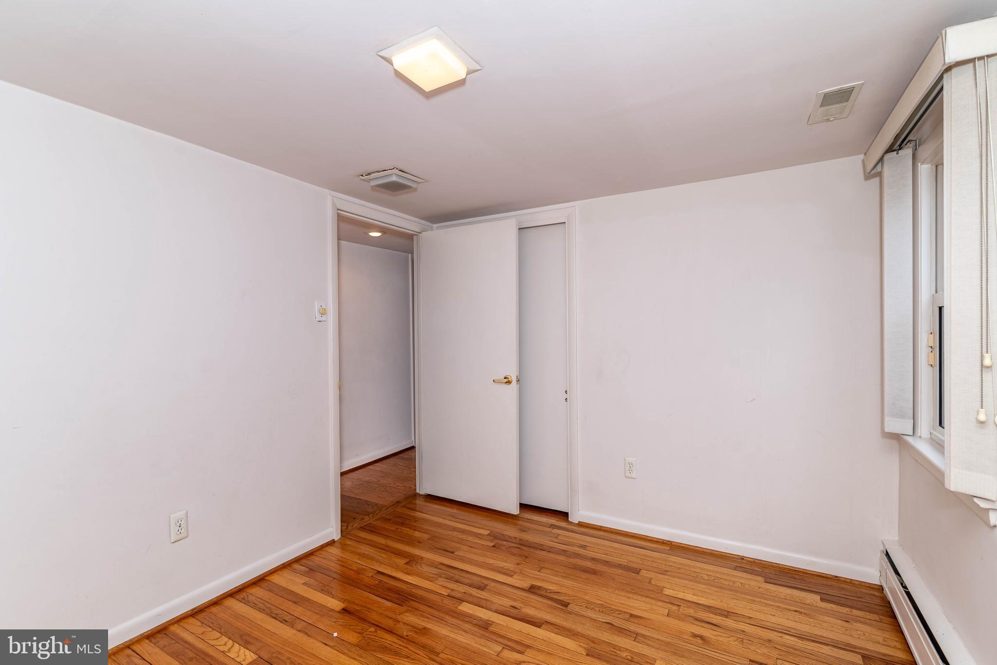 520 Powell Road Mount Holly, NJ 08060 - Photo 34 of 65 a view of an empty room with wooden floor and a window