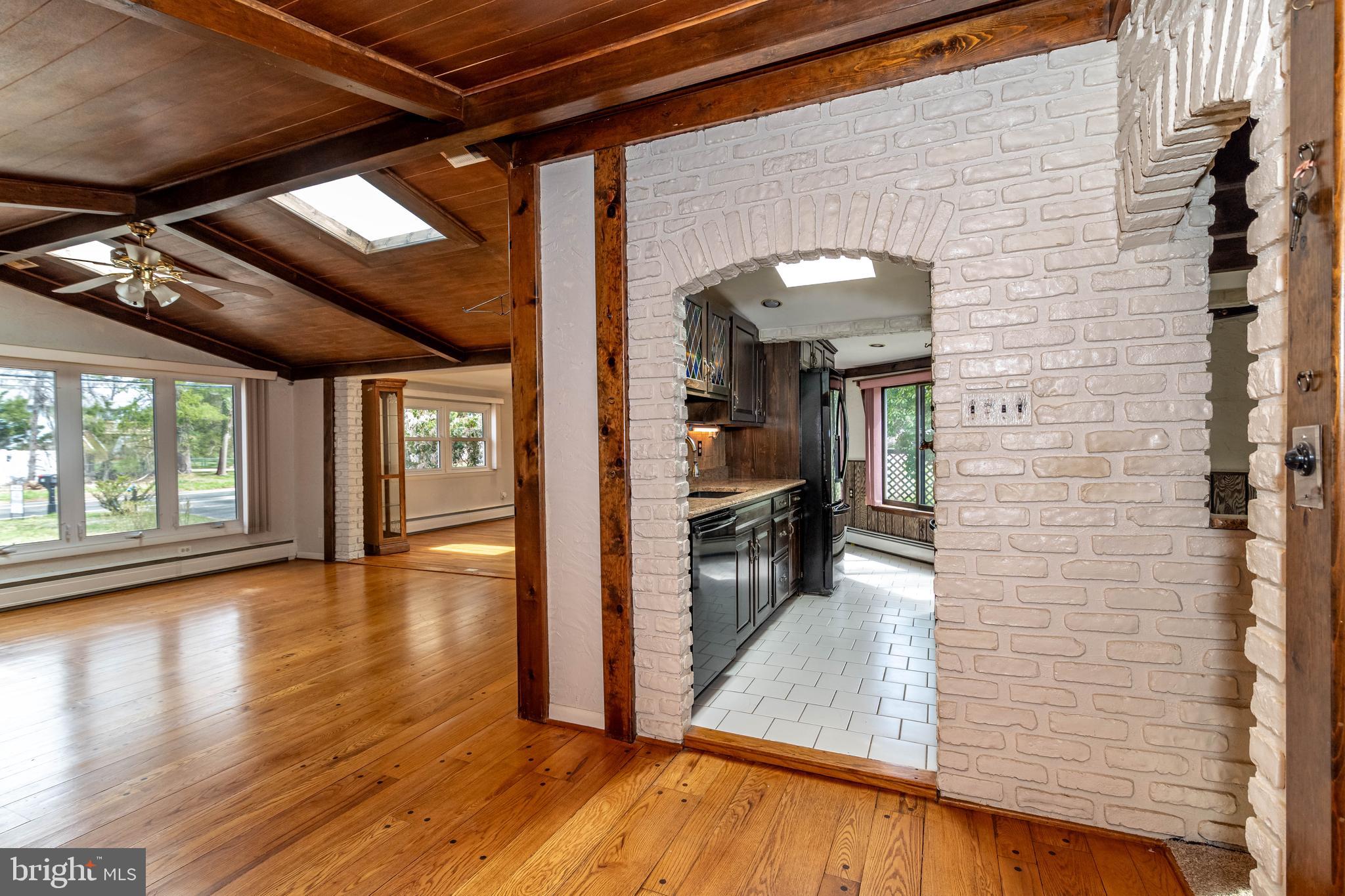 520 Powell Road Mount Holly, NJ 08060 - Photo 7 of 65 a view of a hallway with wooden floor and a kitchen