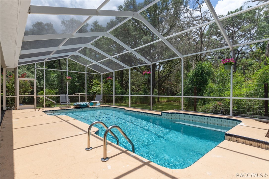 2460 West Pine Ridge Boulevard Beverly Hills, FL 34465 - Photo 7 of 47 a view of a backyard with a swimming pool