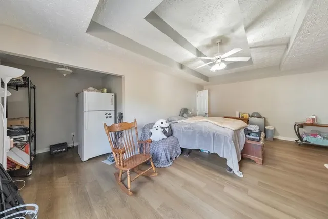 a bed room with a bed and a chair