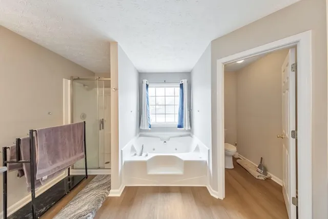 a bathroom with a tub sink and mirror