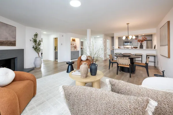 a living room with furniture a table and a fireplace