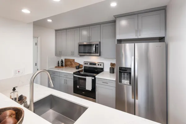 a kitchen with a refrigerator microwave and stove