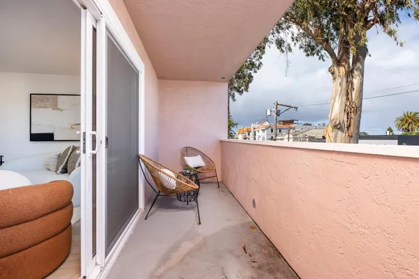 a balcony with table and chairs