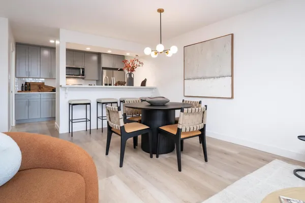 a view of a dining room with furniture and wooden floor