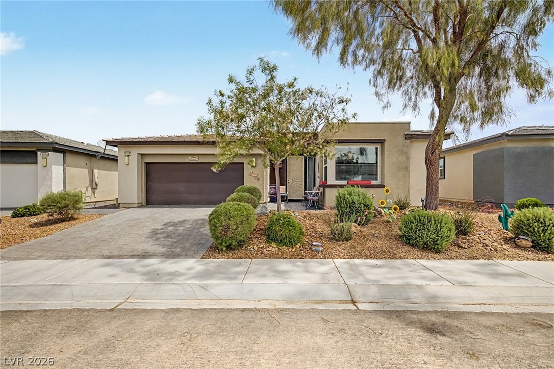 4914 East Beacon Ridge Drive Pahrump, NV 89061 - Photo 5 of 34 A well-maintained desert landscape frames this welcoming single-story residence with an attached garage.