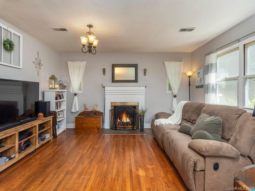 96 Pleasant Hill Road Clyde, NC 28721 - Photo 5 of 16 a living room with furniture a fireplace and a flat screen tv