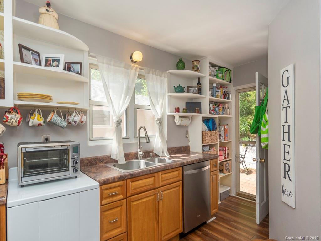 96 Pleasant Hill Road Clyde, NC 28721 - Photo 8 of 16 a kitchen with stainless steel appliances a stove and a refrigerator