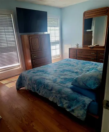 a bedroom with a bed and chair