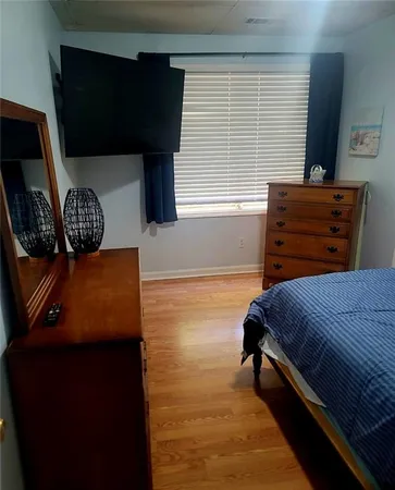 a bedroom with a bed and window