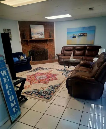 a living room with furniture and a fireplace