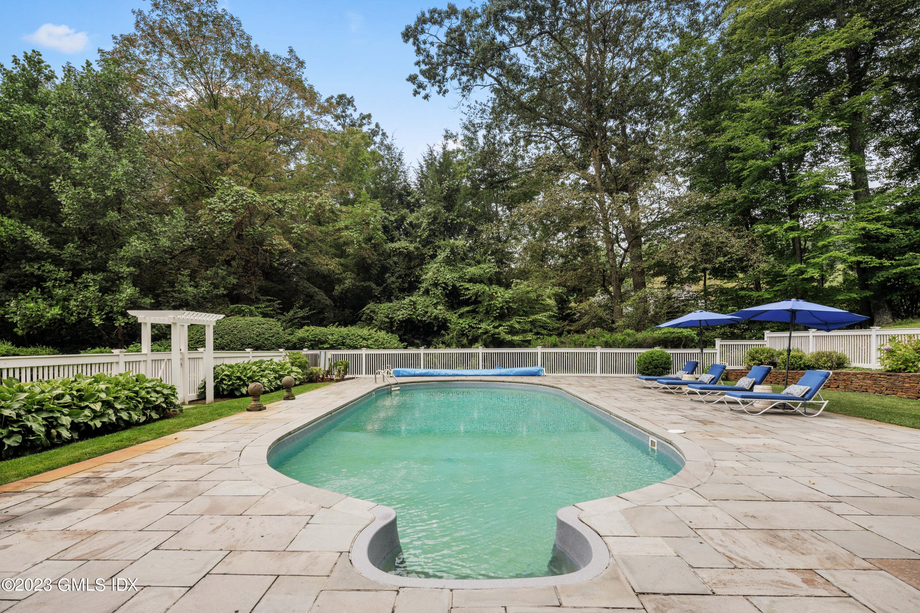 37 North Porchuck Road Greenwich, CT 06831 - Photo 6 of 63 a view of a swimming pool with a patio