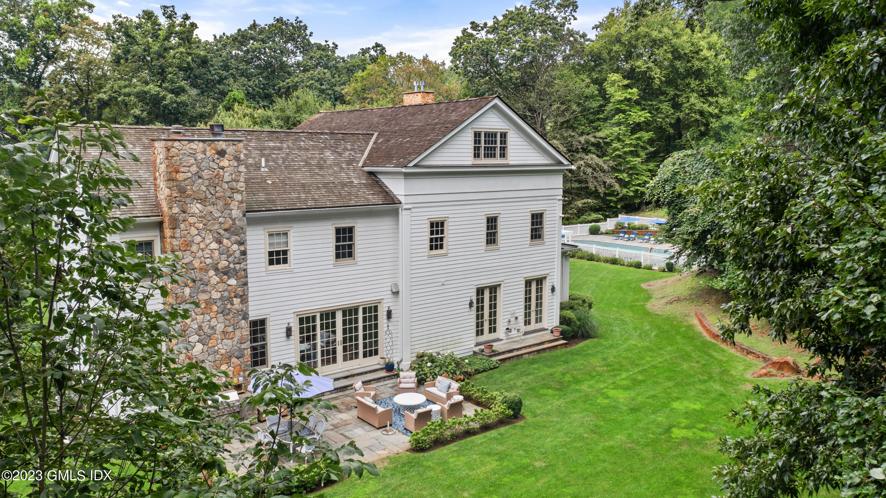 37 North Porchuck Road Greenwich, CT 06831 - Photo 8 of 63 a aerial view of a house with yard and trees in the background