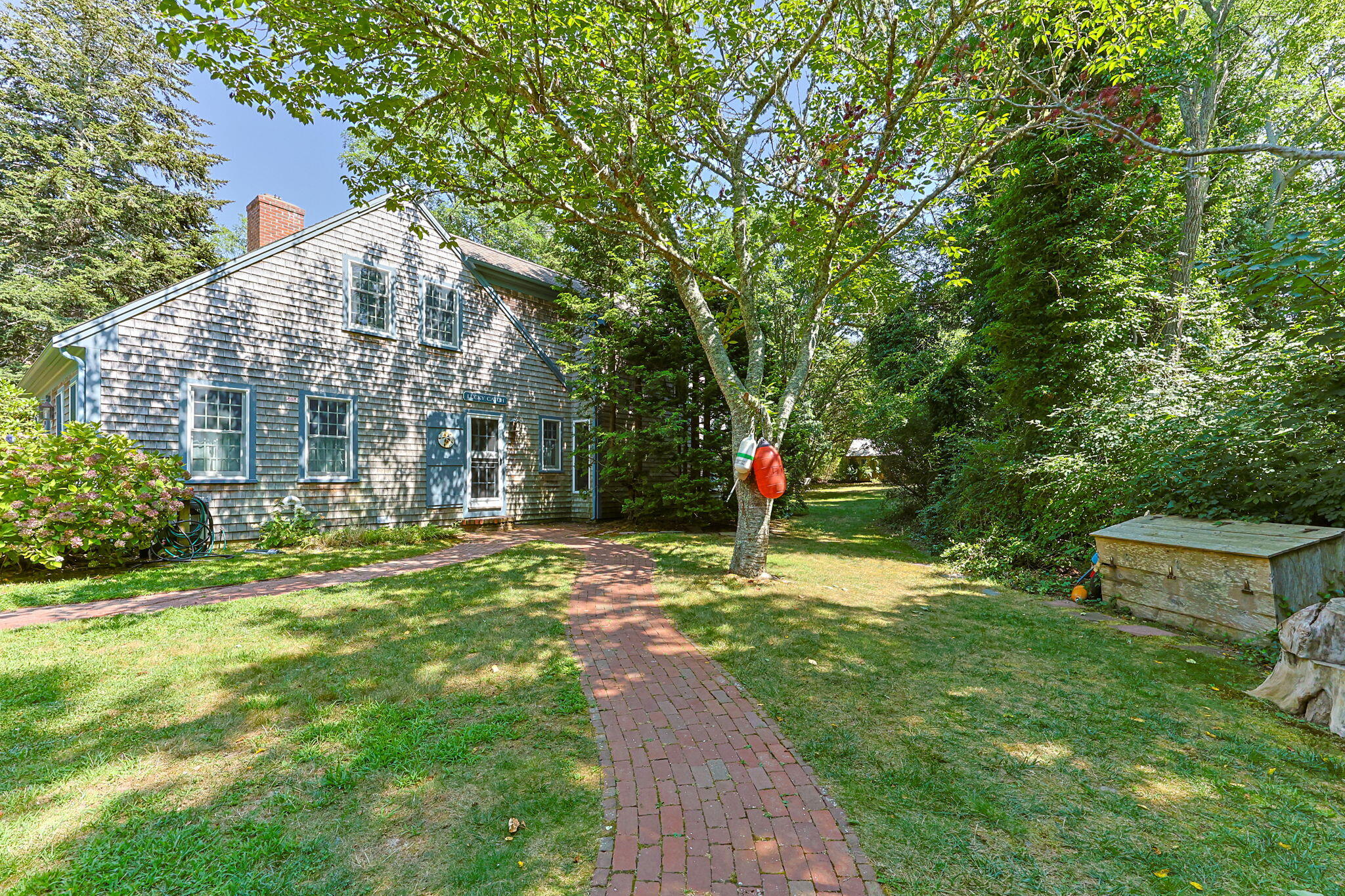 241 Tonset Road Orleans, MA 02653 - Photo 14 of 56 a front view of a house with a yard and tree s