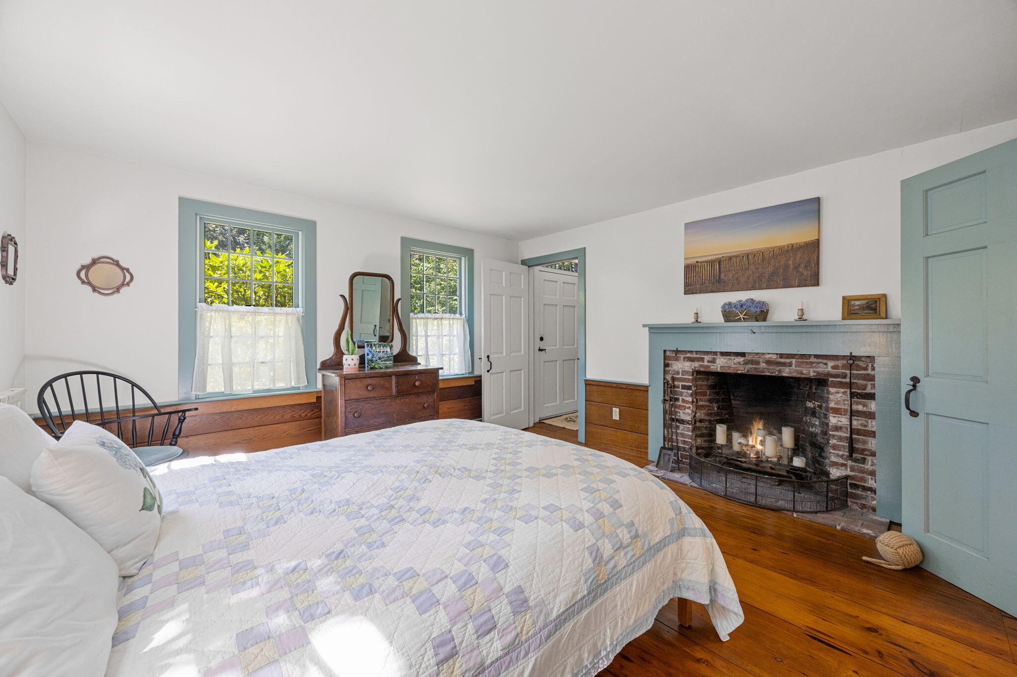 241 Tonset Road Orleans, MA 02653 - Photo 23 of 56 a bedroom with a bed and a fireplace