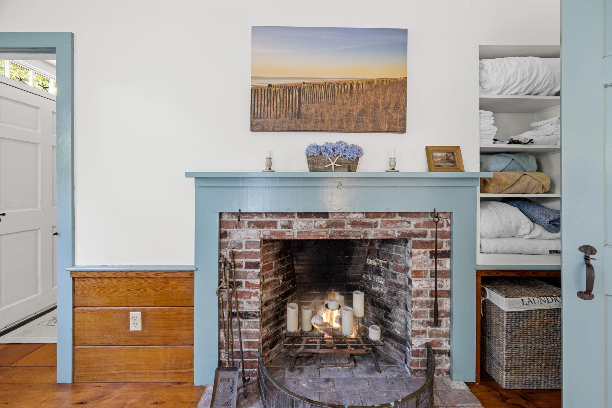241 Tonset Road Orleans, MA 02653 - Photo 24 of 56 a living room with a fireplace and a wooden floor