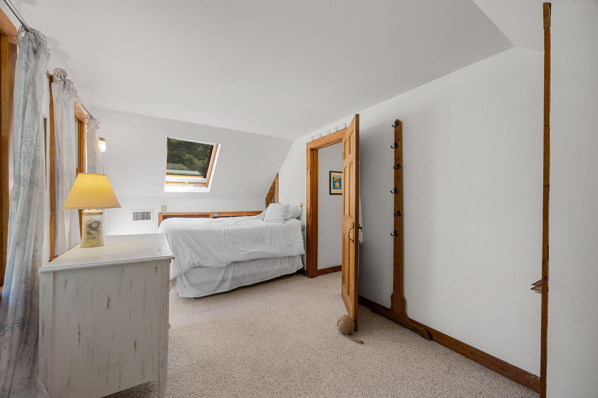 241 Tonset Road Orleans, MA 02653 - Photo 32 of 56 a bedroom with a bed and a lamp