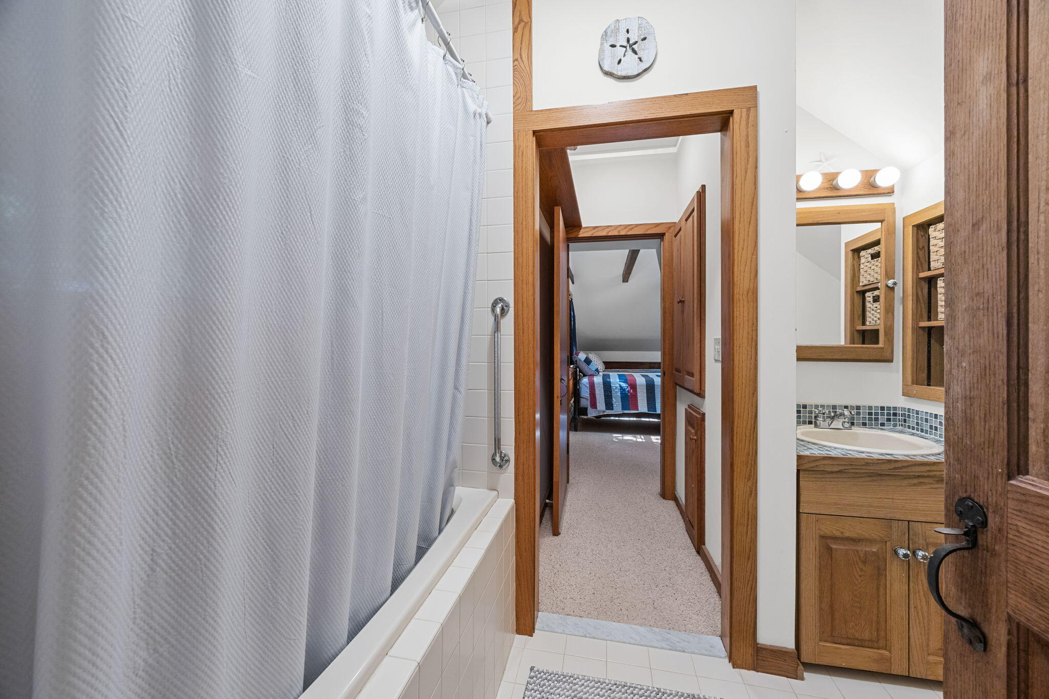 241 Tonset Road Orleans, MA 02653 - Photo 37 of 56 a en suite bathroom with a sink and mirror