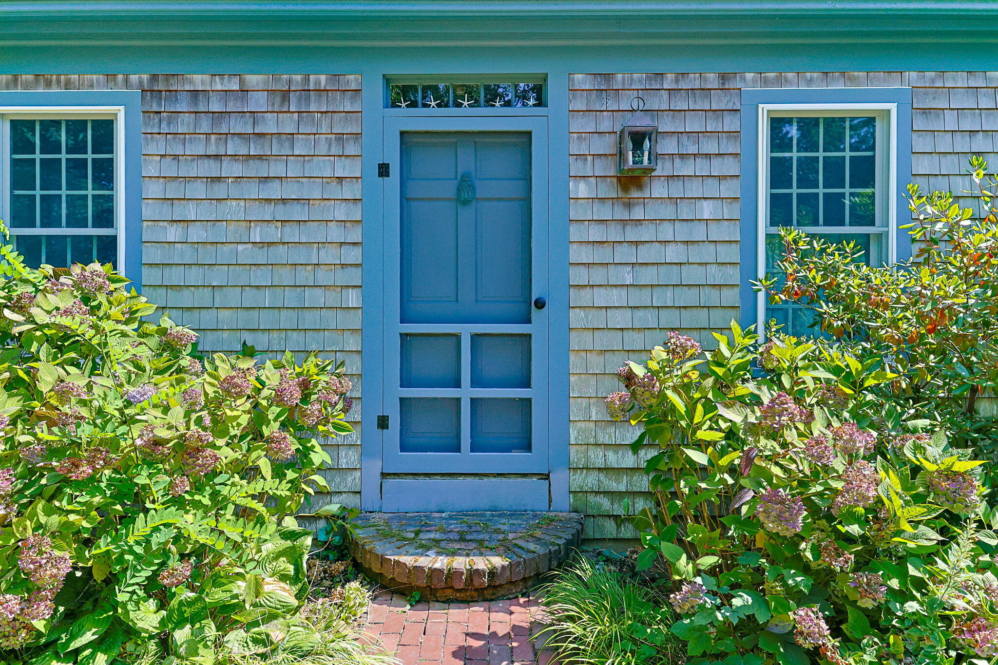 241 Tonset Road Orleans, MA 02653 - Photo 4 of 56 a couple of potted plants in front of door