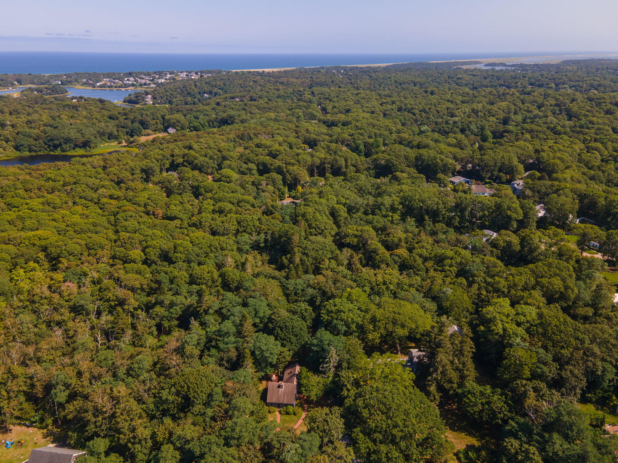 241 Tonset Road Orleans, MA 02653 - Photo 43 of 56 a view of a city with lush green forest