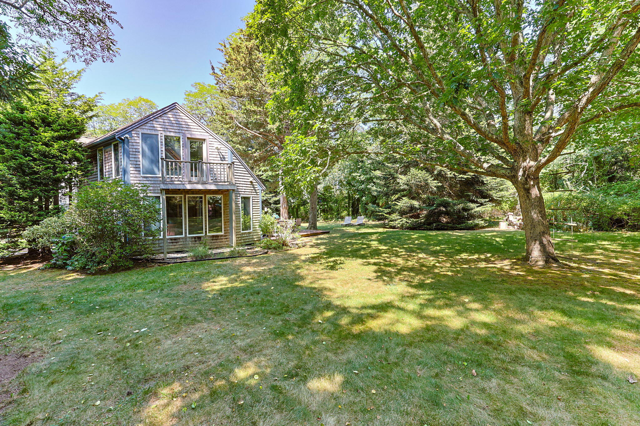 241 Tonset Road Orleans, MA 02653 - Photo 5 of 56 a front view of a house with a garden