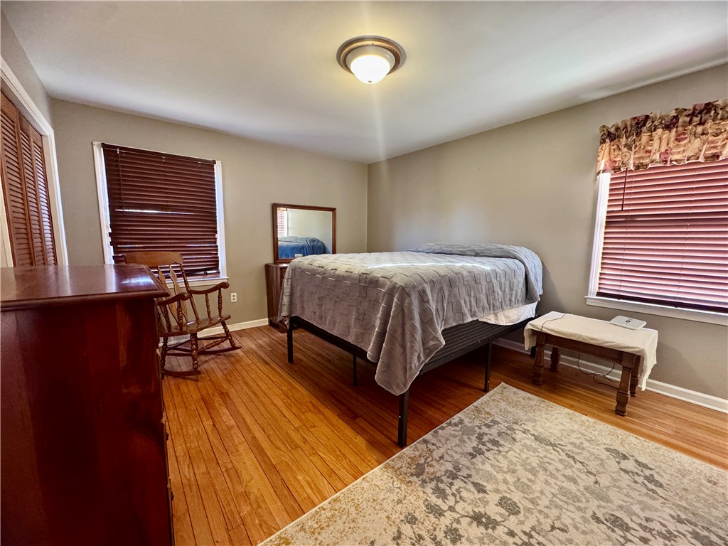 208 Pilgrim Circle Pickens, SC 29671 - Photo 24 of 29 This cozy bedroom features polished hardwood floors and ample natural light, creating a comfortable and inviting atmosphere.