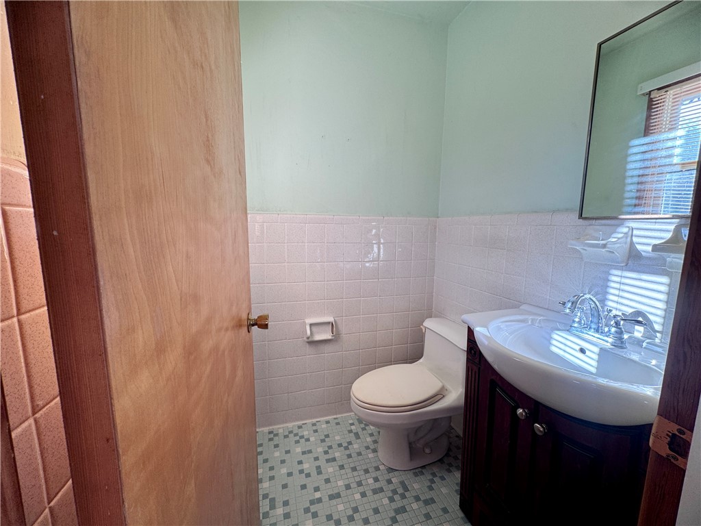 208 Pilgrim Circle Pickens, SC 29671 - Photo 27 of 29 This bathroom features a sleek vanity and mosaic tile flooring, offering a functional and clean aesthetic.