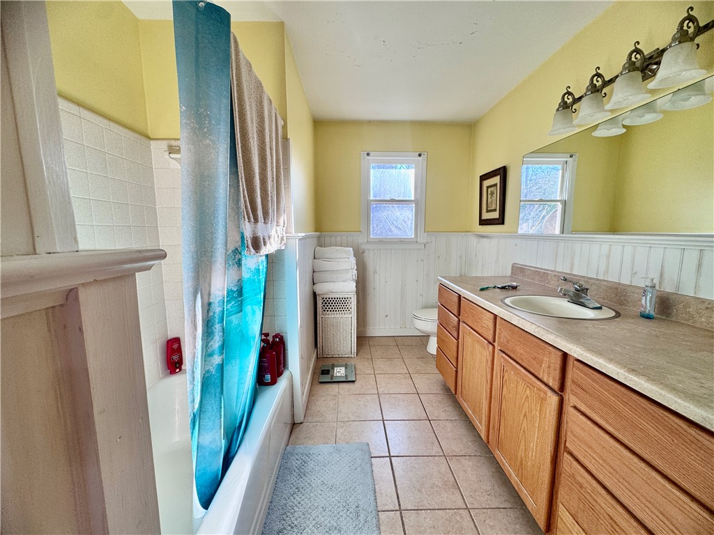 208 Pilgrim Circle Pickens, SC 29671 - Photo 28 of 29 This bright bathroom features a vanity, tiled flooring, and a window.