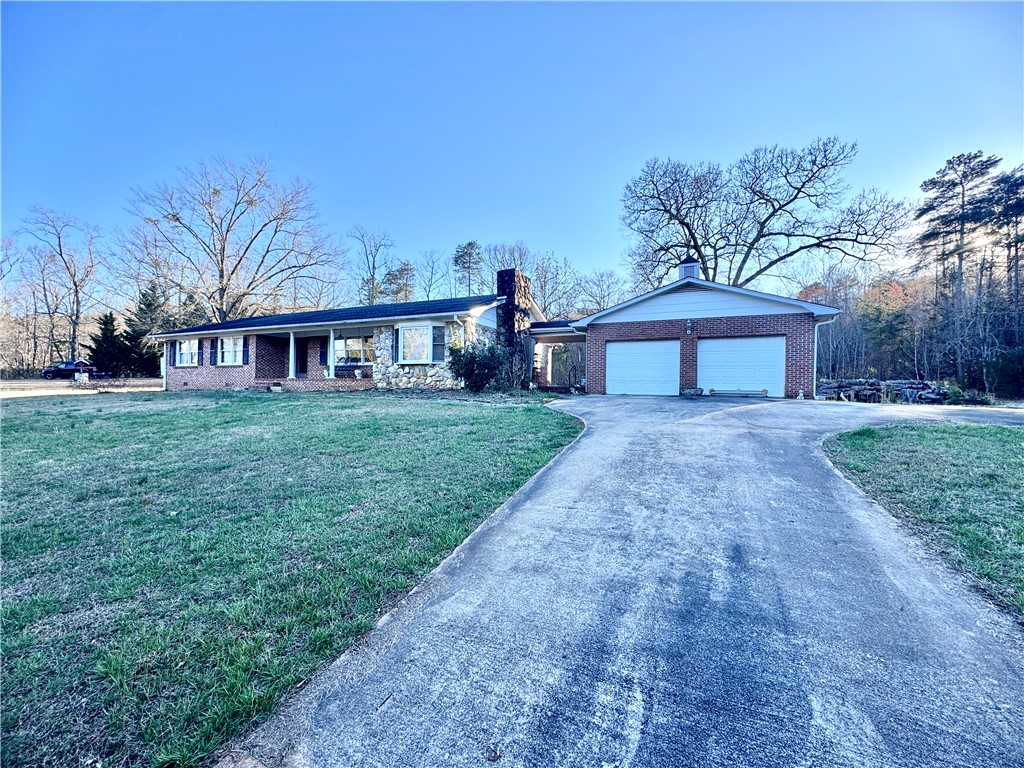 208 Pilgrim Circle Pickens, SC 29671 - Photo 29 of 29 This residence features a broad front lawn, an attached garage, and a long paved driveway.