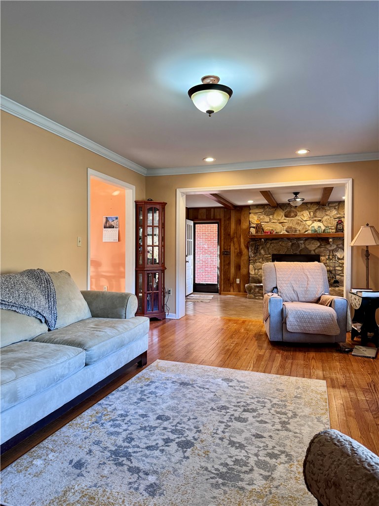 208 Pilgrim Circle Pickens, SC 29671 - Photo 4 of 29 This inviting living area features warm wood flooring and is open to the great room with a classic fireplace, perfect for relaxation.