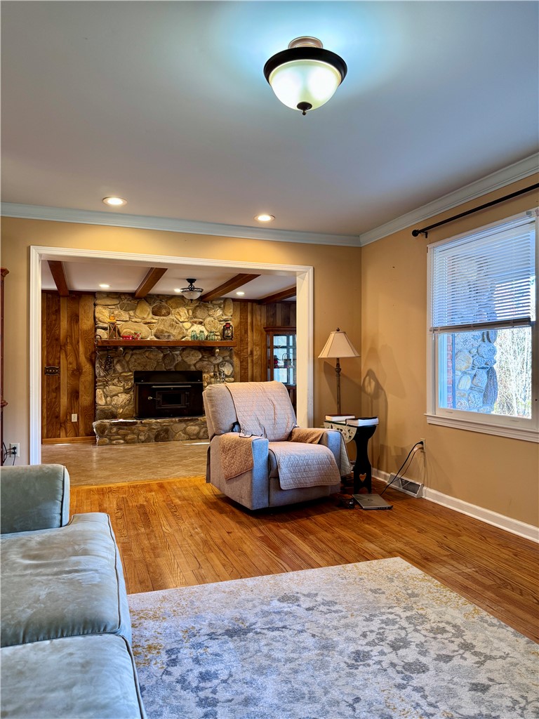 208 Pilgrim Circle Pickens, SC 29671 - Photo 5 of 29 This inviting living area boasts ceramic tile floors and a cozy stone fireplace, perfect for relaxation.