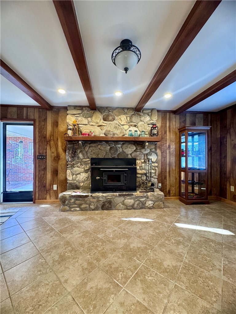 208 Pilgrim Circle Pickens, SC 29671 - Photo 6 of 29 This inviting space features a charming stone fireplace and easy-care tiled flooring, perfect for cozy gatherings.
