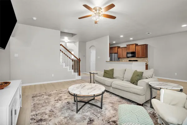 a living room with furniture and a wooden floor