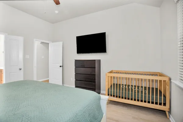 a bedroom with a bed and a flat screen tv