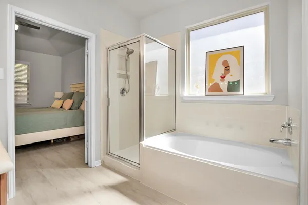 a bathroom with a tub and a shower