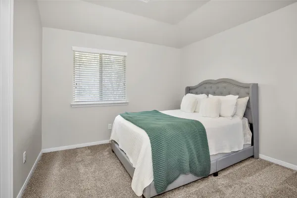 a bedroom with a bed and window
