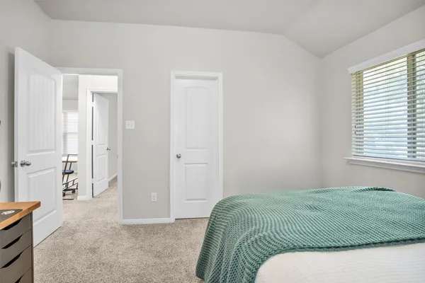a bedroom with a bed and with furniture